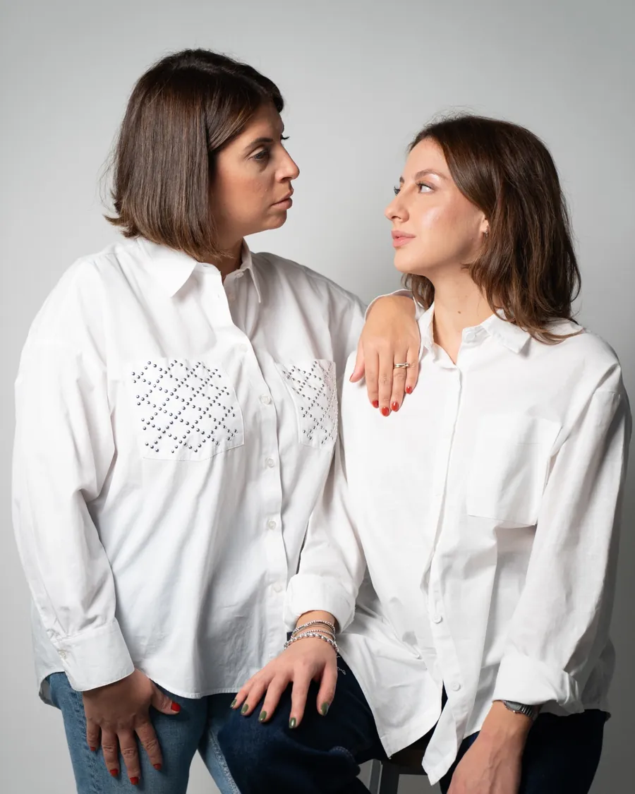 Antonella e Francesca in camicia bianca si guardano